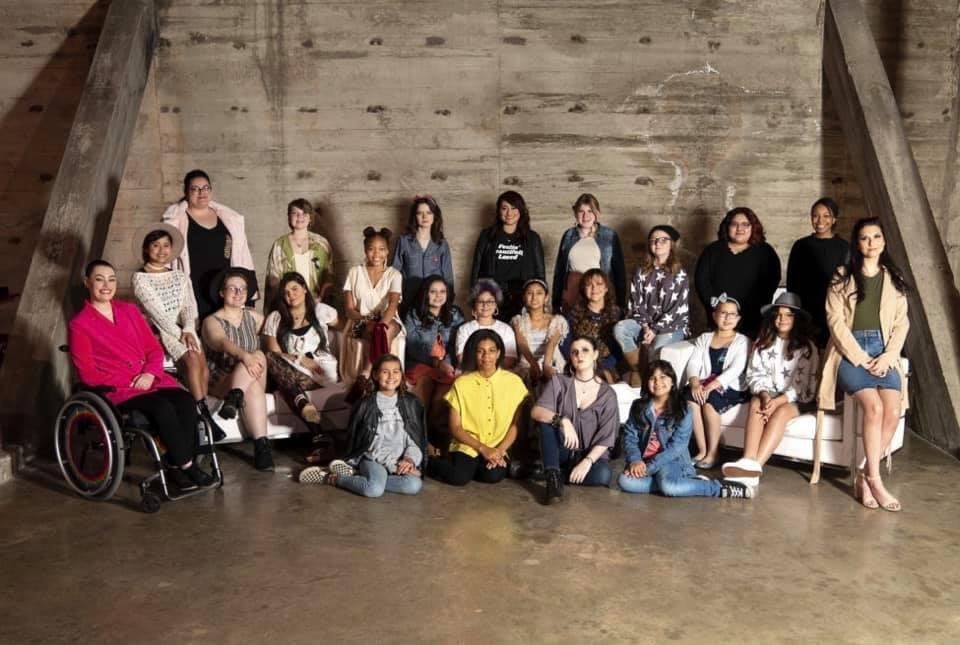A group of Beautifully Loved models and ambassadors posing together for a studio photograph